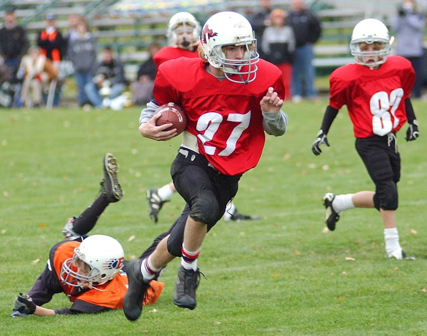 <who>Photo Credit: Lorne White/KelownaNow </who>Rhys Onofrychuk evades an attempted diving tackle from Sean Hawkins in a Kelowna Minor Football Association junior bantam game at Mission Sportsfields in 2004. Onofrychuk went on to play high school football with the Kelowna Owls while Hawkins played for the Okanagan Mission Huskies.