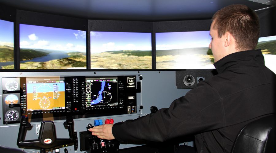 </who> A student of Okanagan College's Commercial Aviation Program practicing in the simulator.