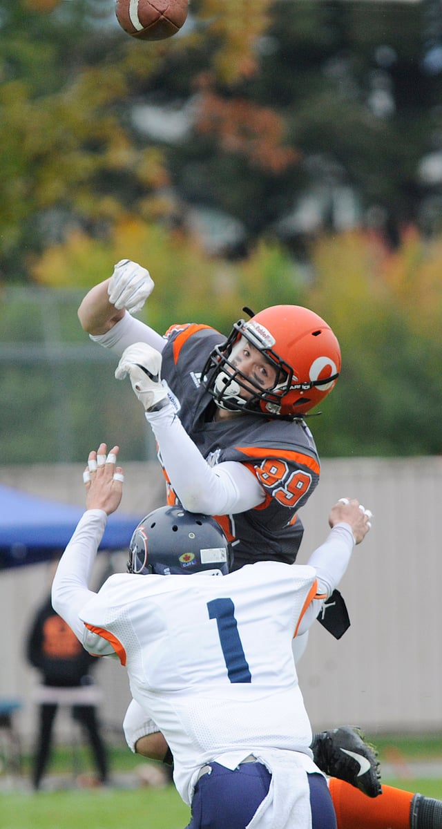 Sun receiver, Adam Burton, is hit hard by Michael Baerg while leaping to get his hands on a Matthew Mahler pass.