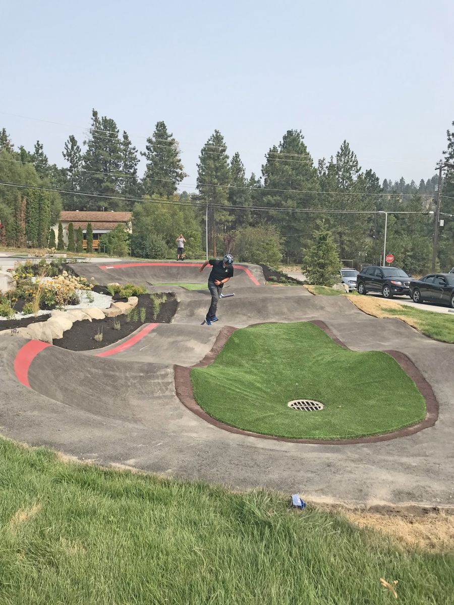 <who>Photo Credit: Jacquie Biblow</who>Councillor Tom Konek going for a whirl on the state-of-the-art Pump Track