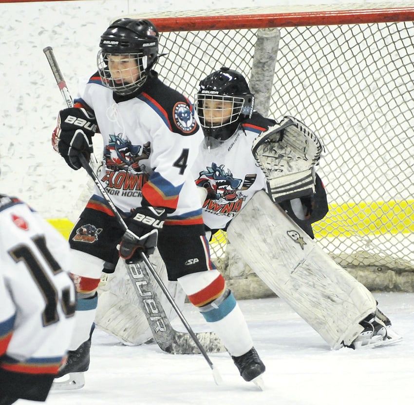 <who>Photo Credit: Lorne White/KelownaNow </who>Rockets Luke Schraeder and goaltender Angelo Zol have the net well covered in their game against Calgary.