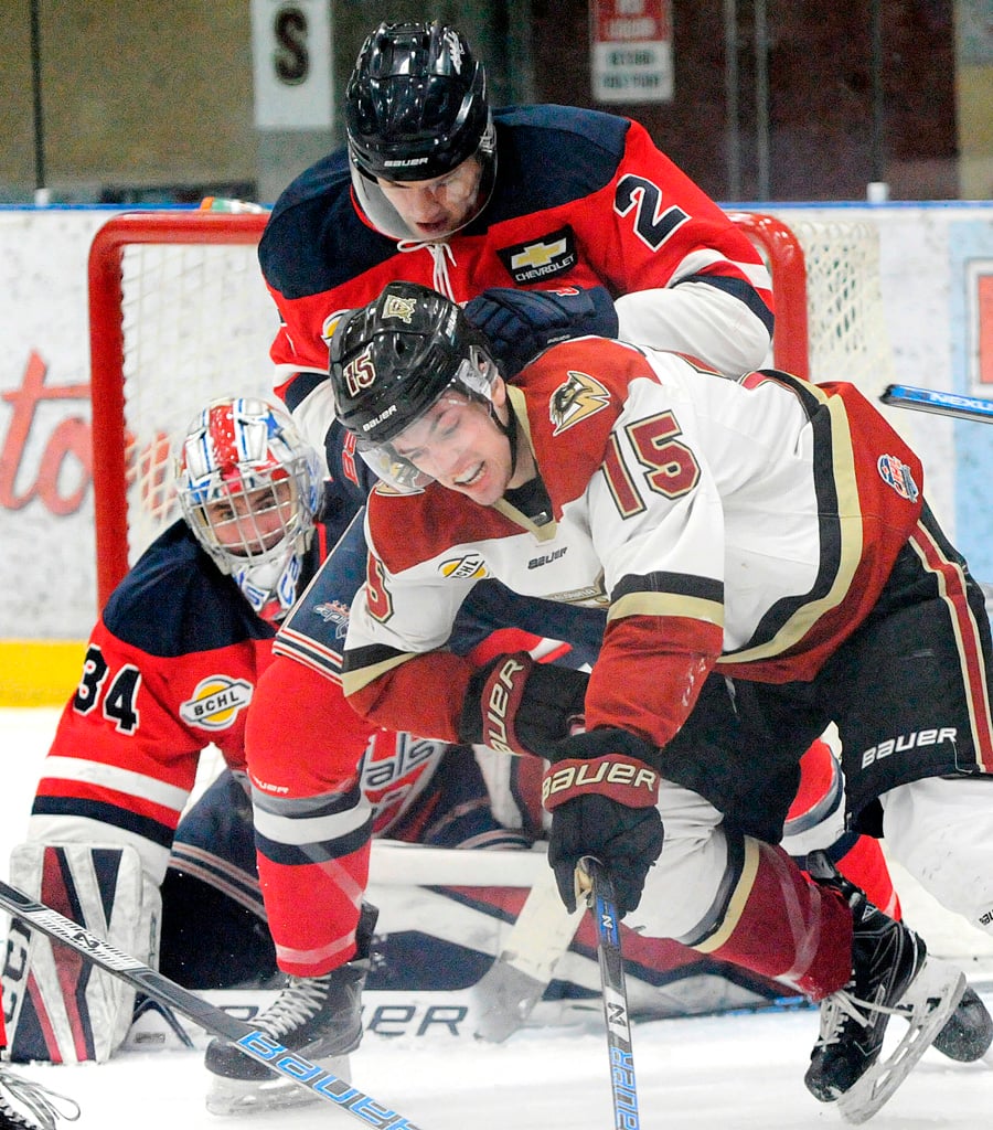 <who>Photo Credit: Lorne White/KelownaNow </who>Eric Olson of the Warriors battles with Cowichan Valley's Peter Tabor in front of goaltender Jack Grant.