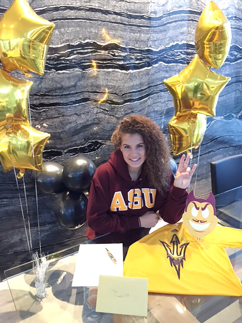 <who>Photo Credit: Contributed </who>Taya Hanson is all smiles at the official signing with Arizona State University and the W. P. Carey Business School.