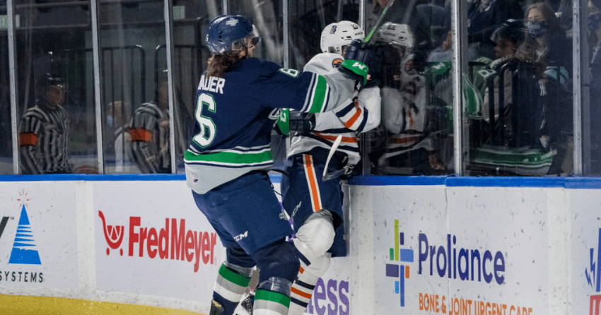 Thunderbirds captain and 2020 Winnipeg Jets draft pick Tyrel Bauer flattens centre Dylan Sydor in a November game.