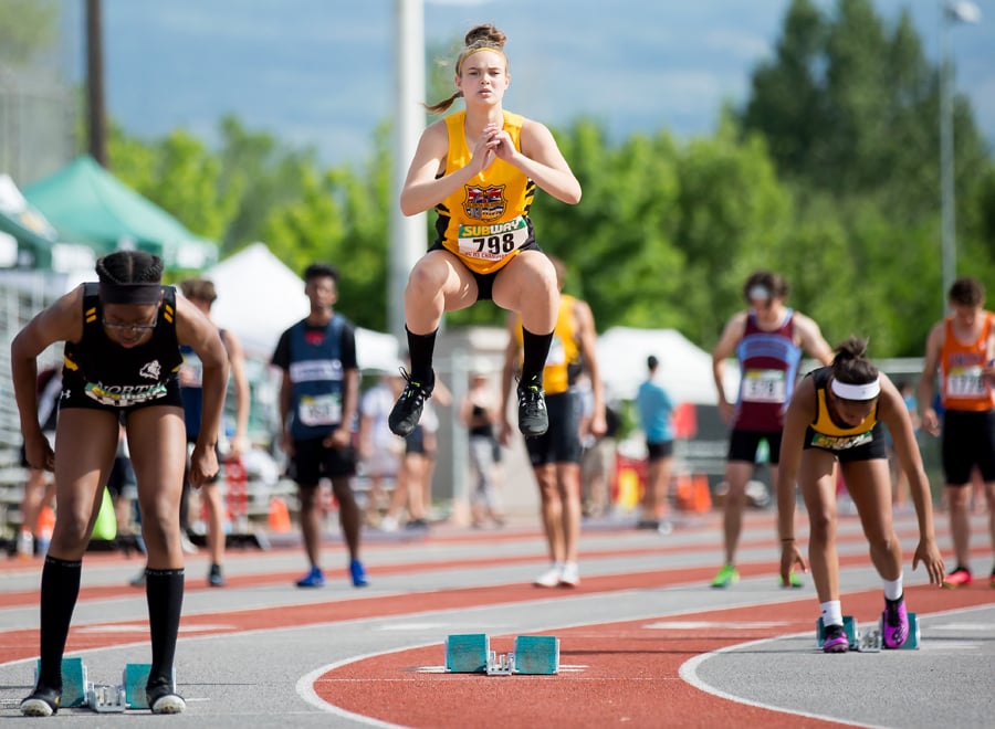 <who>Photo Credit: Candid Apple Photography </who>Cannan limbers up on the start line of the 200-metre final. She went on to win the race with a provincial record.