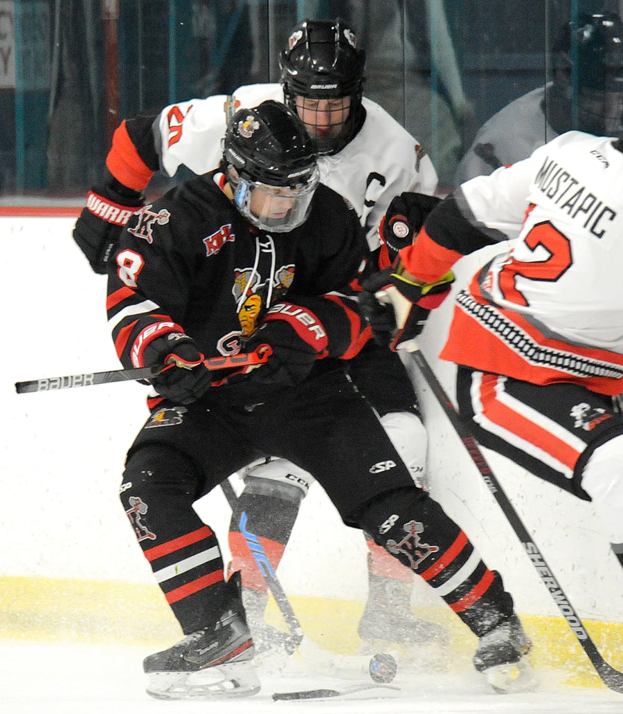 Kaden Meszaros of the Chiefs and Summerland's Cody Swan battle for possession along the boards. Swan went on to score three times and add a pair of assists.