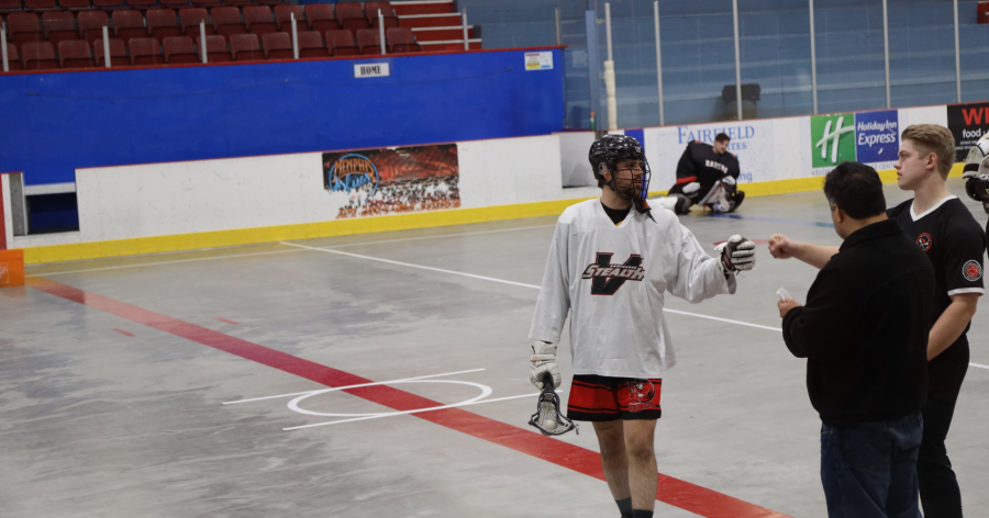 <who> Photo Credit: NowMedia </who> Garant, seen here chatting with a minor league lacrosse official, has an extensive playing career prior to the Raiders, and was selected in the sixth round of the 2017 NLL Draft. 