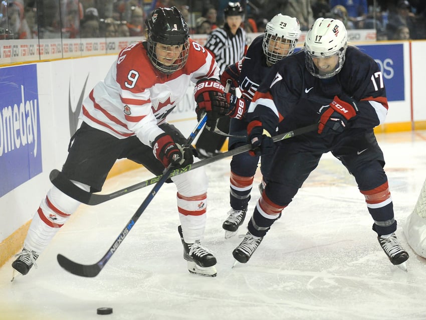 <who>Photo Credit: Lorne White/KelownaNow.com </who>Jennifer Wakefield of Canada battles for possession behind the U.S. net with Monique Lamoureaux.