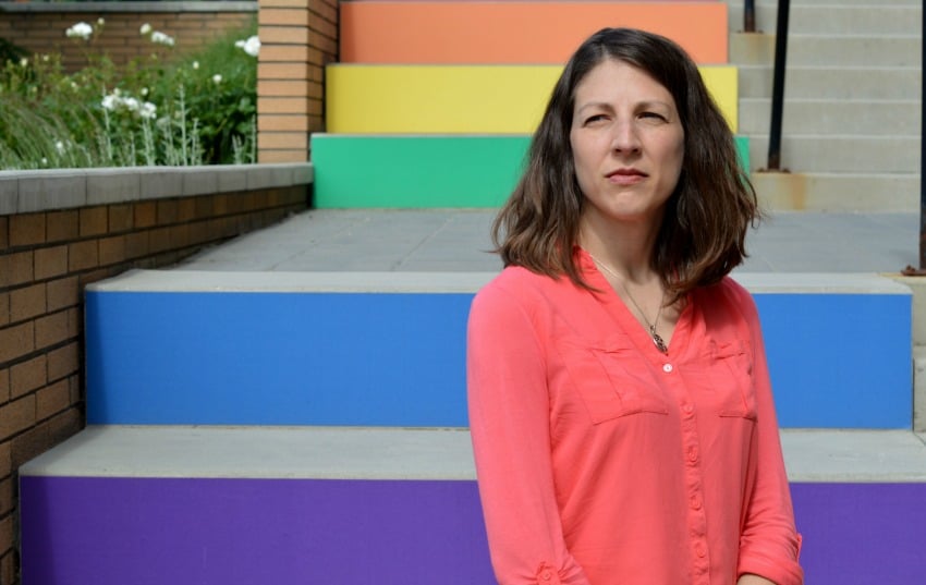 <who> Photo Credit: UBC Okanagan </who> Susan Holtzman stands in front of the 'rainbow staircase' of inclusion at UBC's Okanagan campus. 