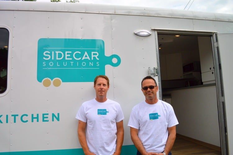 Chris Gjernes (left) and Tom Calne stand outside of the Sidecar Solution.