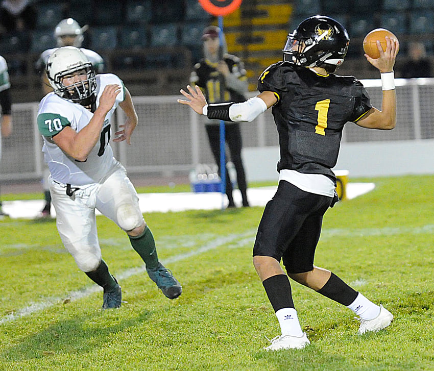 Kelowna Owls' quarterback, Isaac Athans, about to deliver a touchdown pass to Nolan Ulm on KSS's first offensive sequence.