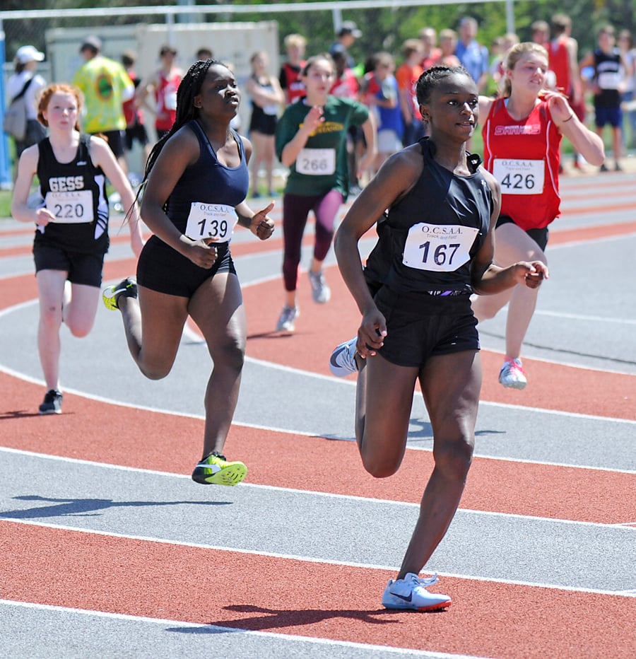 Teja Wilson (167) and Gabrielle Blake (139) round the final turn on the way to a third- and second-place finish respectively in the Grade 8 200-metre race.