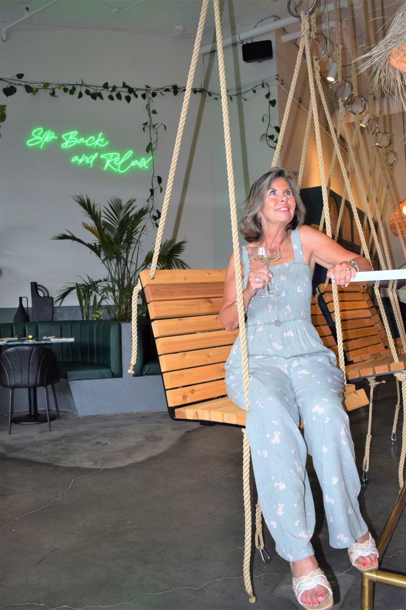 </who>There are swing chairs at the bar and looking out onto the patio.