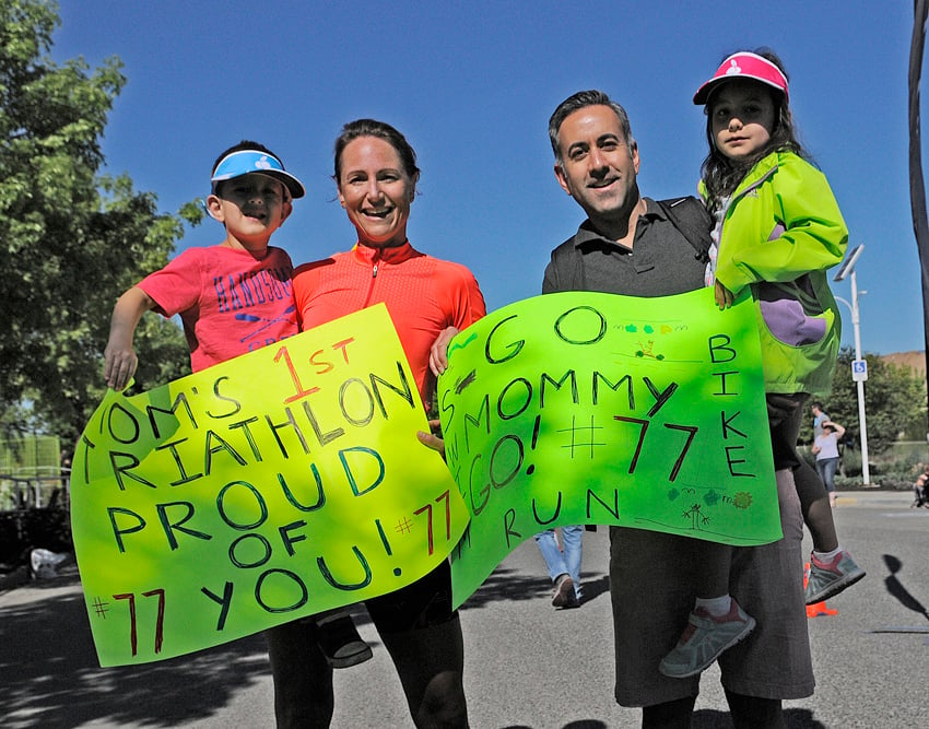<who>Photo Credit: Lorne White/KelownaNow </who>Leanne Basran, with her children and husband, Kelowna mayor Colin Basran, completed her first triathlon in 1:33:32, good for third place in the women's 40-44 age category. She was one of about 35 first-time triathlon participants.