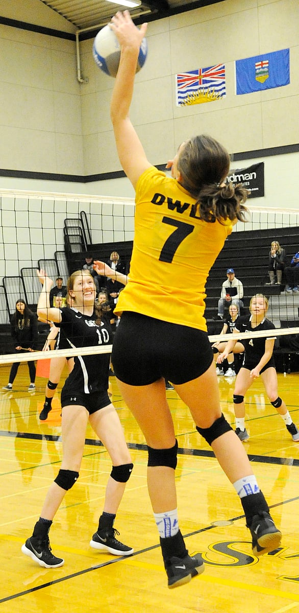 <who>Photo Credit: Lorne White/KelownaNow </who>The Owls' Sophie Lachapelle spikes the ball in the second set of their quarter-final match against the George Elliot Coyotes. On the left for GESS is Georgia MacLean. Teammate Jasanna Kunz in on the right.