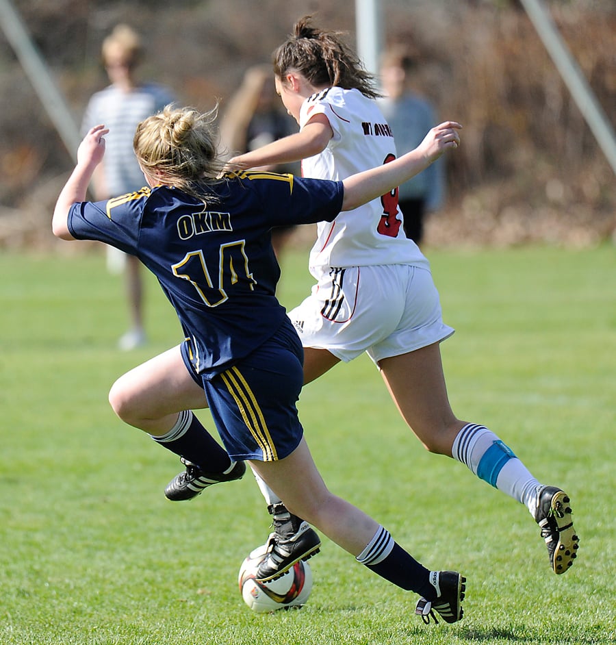 OKM's Sammi Krupka, left, and the Bears' Jessica Skerlec chase down a loose ball.