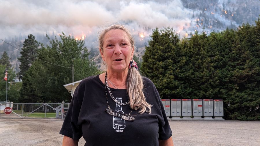 <who>Photo Credit: NowMedia/Gord Goble</who> Anne Cameron (foreground) Crater Creek fire (background)