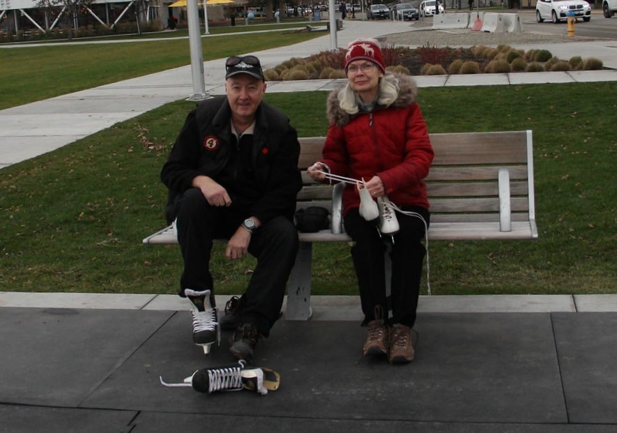 <who>Photo Credit: KelownaNow</who>This couple straps on their skates, ready for opening day at the rink.