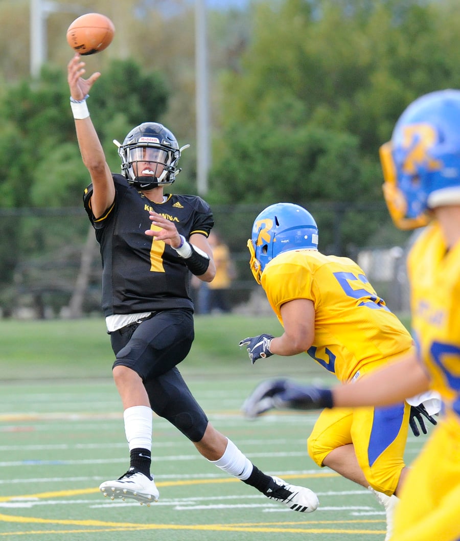 <who>Photo Credit: Lorne White/KelownaNow </who>Kelowna Owls’ quarterback Isaac Athans throws on the run to Caeleb Schlachter early in the game against the Rutland Voodoos.