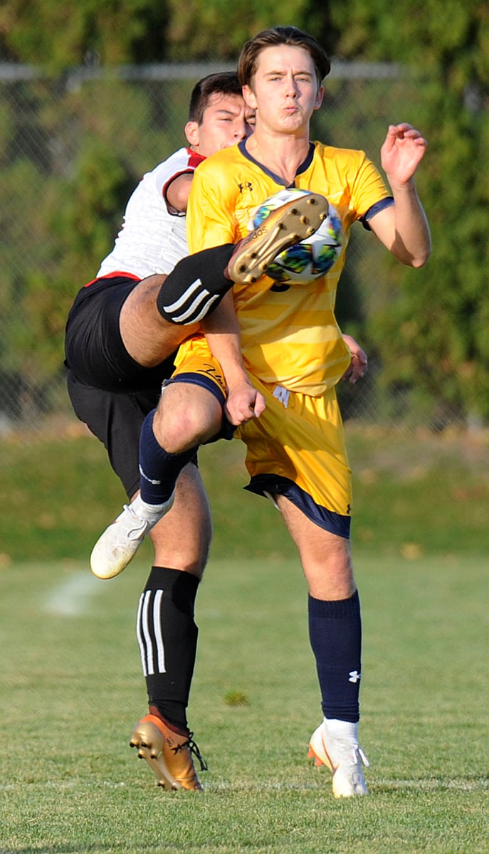 Nemanja Vracarevfic of the Mt. Boucherie Bears wraps his leg around Aaron Brears of OKM in an attempt to gain control.