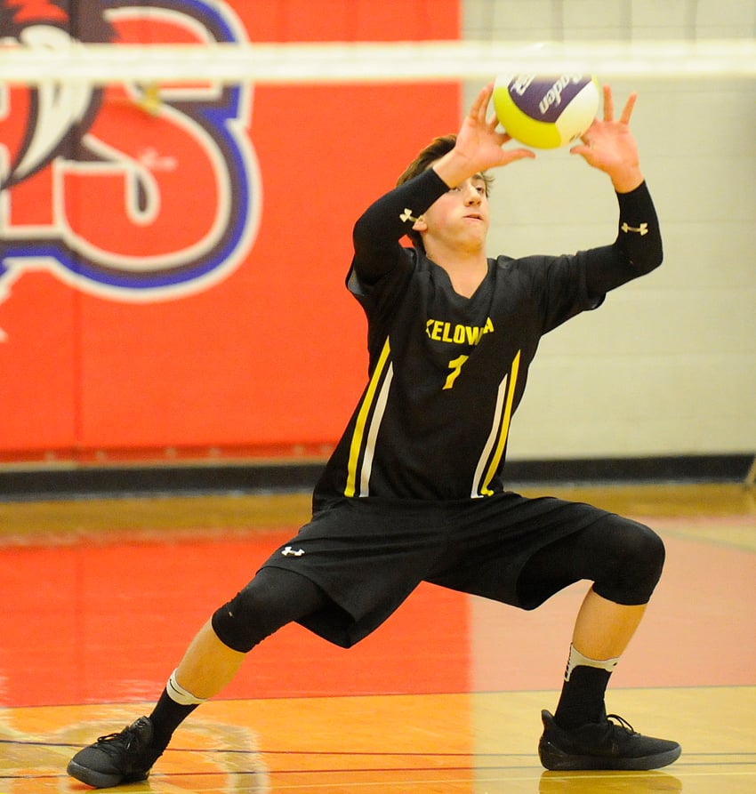 <who>Photo Credit: Lorne White/KelownaNow </who>KSS Libero Jase Goerzen receives a serve against College Heights of Prince George.