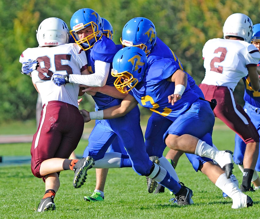 The Voodoos, led by Dalton Lucas, left, and Prince Manongdo, foreground, gang-tackle Hamber Griffin.