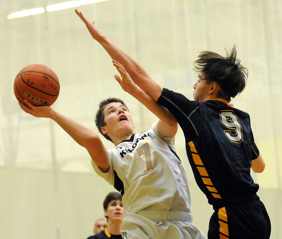 <who>Photo Credit: Lorne White/KelownaNow </who>Valley all-star, Nate Beauchemin, of the Owls in tough against the Huskies' Kaden Kiewitz.