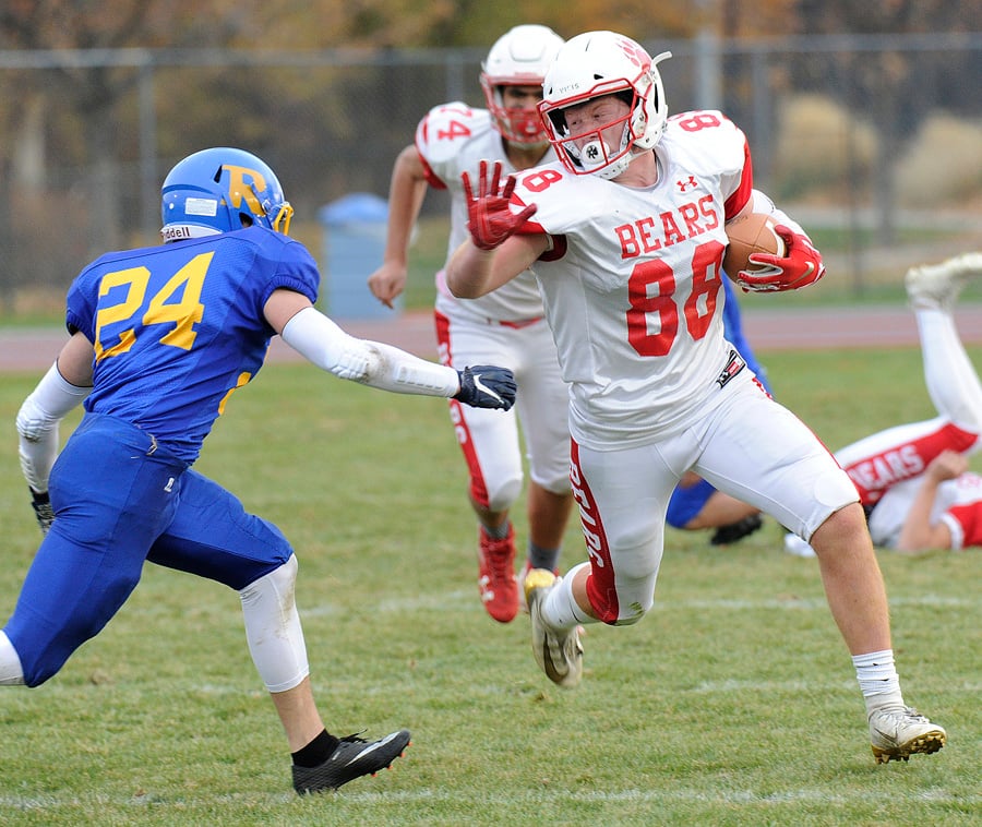 Bronte Gallo of the Mt. Boucherie Bears ran to a first down before being tackled by Rutland's Pacific Conference all-star Kai Brydon.