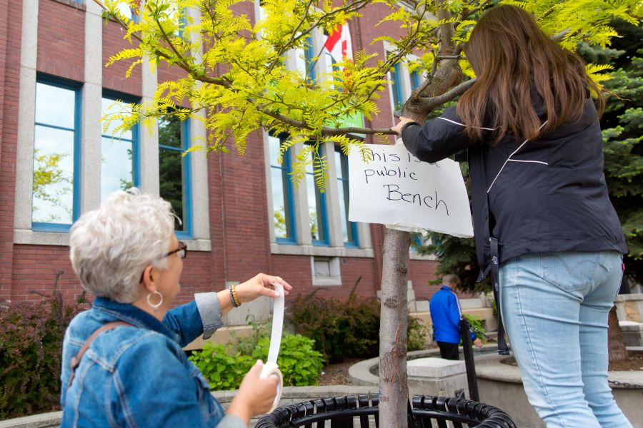 Vivian Short and Crystal Woodward put up a sign