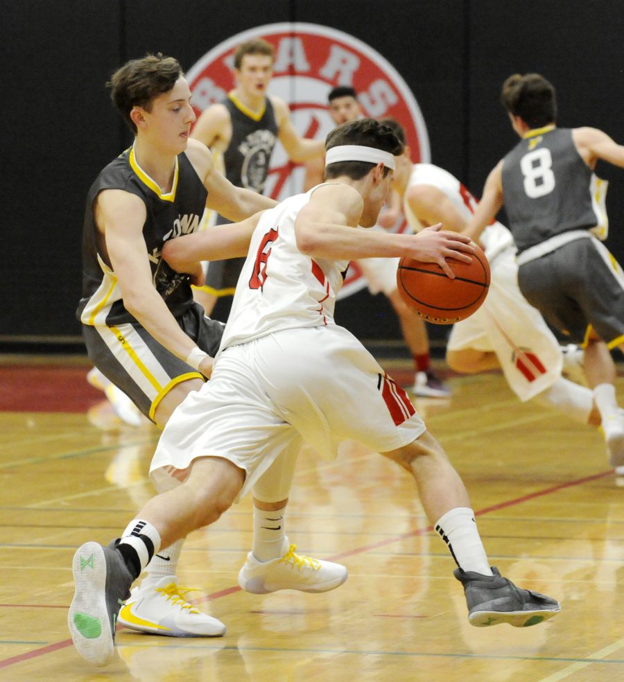 <who>Photo Credit: Lorne White/KelownaNow </who>Boucherie's Jake Semeniuk takes a quick stride past the Owls' Malcolm Greggor at mid-court.