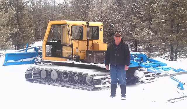 <who> Photo Credit: Contributed. </who> Groomer Al with the ski club's snowcat.