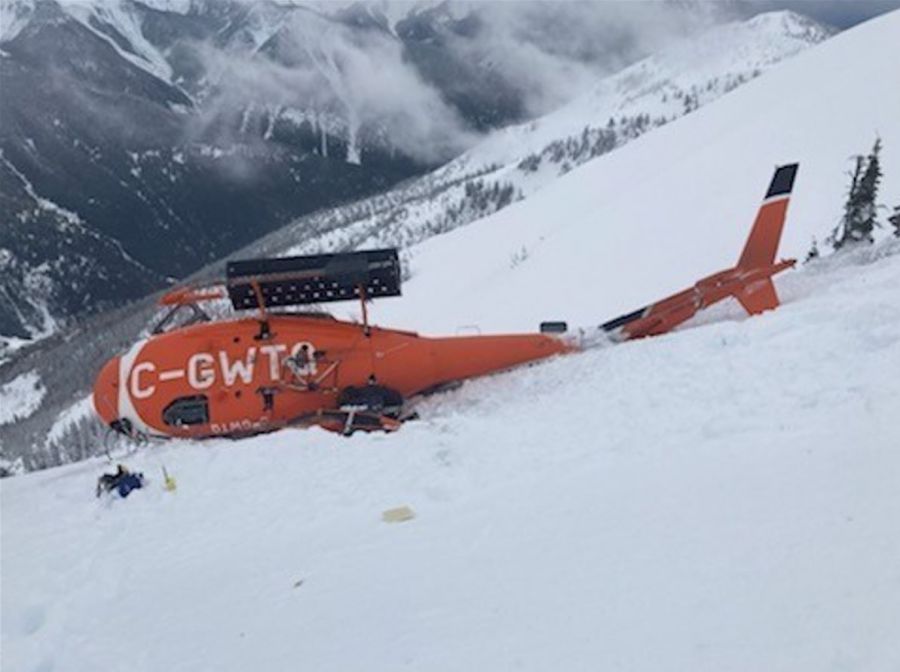 <who>Photo Credit: Ministry of Transportation</who>The helicopter lying on its side on the mountain after crashing.
