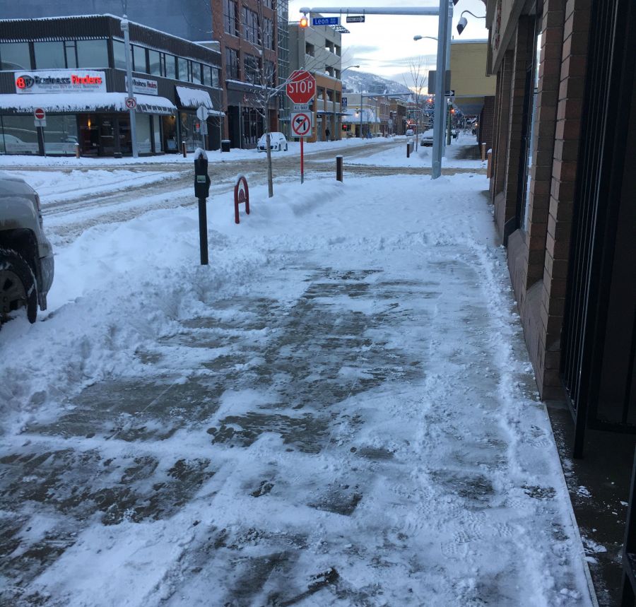 <who>Photo Credit: KelownaNow</who>A properly shoveled walk next to a sidewalk that has been ignored.