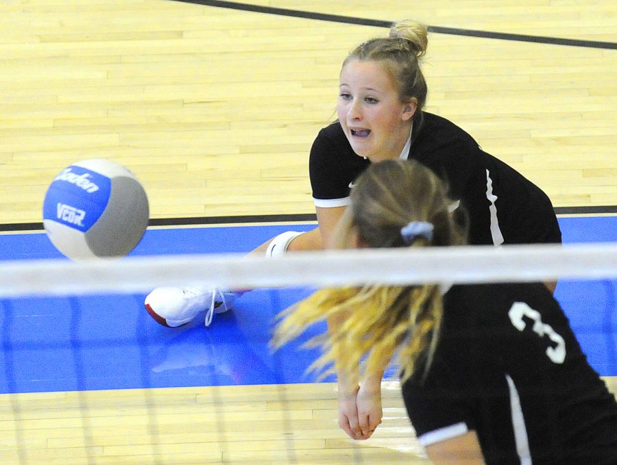 <who>Photo Credit: Lorne White/KelownaNow </who>Thea Lee of the Coyotes digs a KSS serve in quarter-final play.