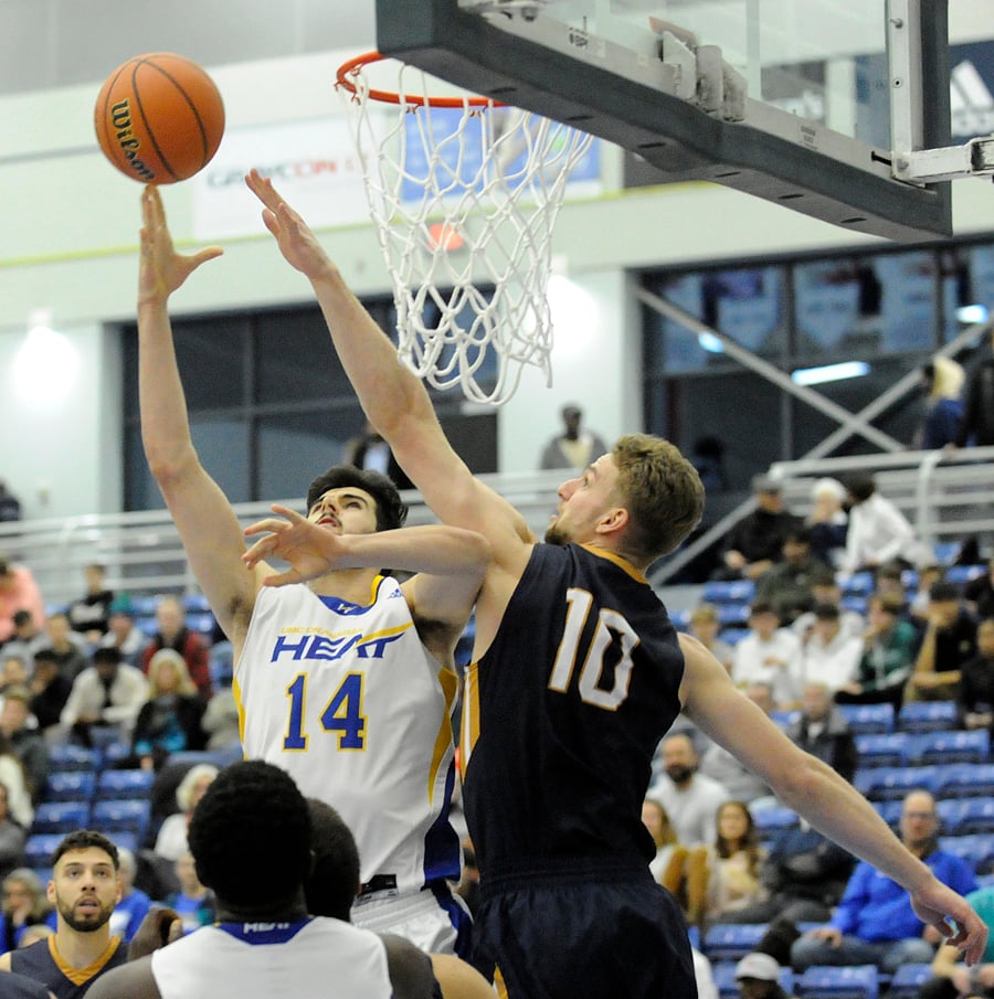 Former KSS Owl teammates, Owen Keyes and Grant Shephard battle for a rebound the first quarter.