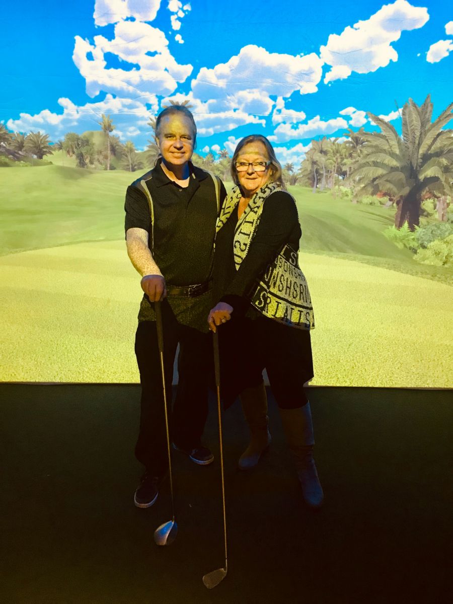 <who>Photo Credit: Contributed</who>Simplex Sportszone's Erwin and Rita Egert in front of one of their huge golf screens.