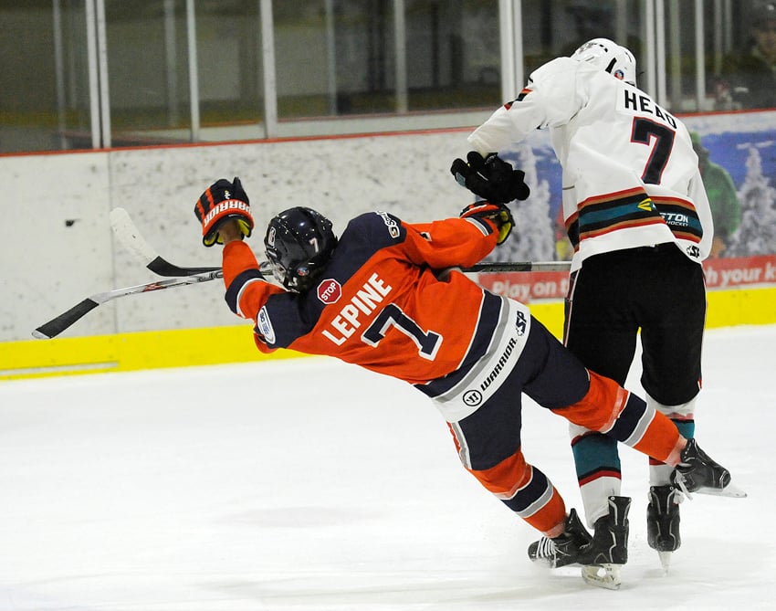 <who>Photo Credit: Lorne White/KelownaNow </who>The Okanagan Rockets' Wyatt Head bodychecks Rhys Lepine of the Thompson Blazers to the ice in the visitors' end. Head went on to score a goal on Sunday in a 5-3 loss.