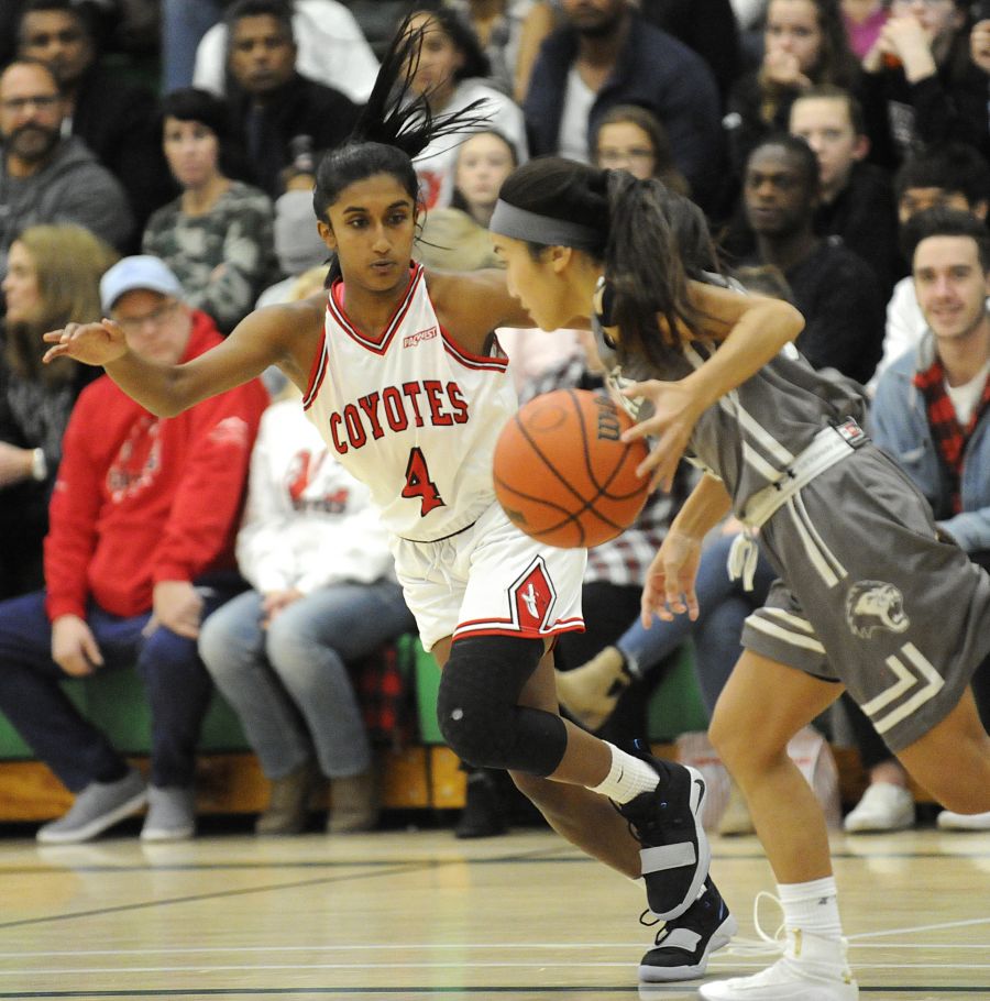 <who>Photo Credit: Lorne White/KelownaNow </who>OC point guard, Sapna Deo goes on the defence in the second half of their game against Douglas.