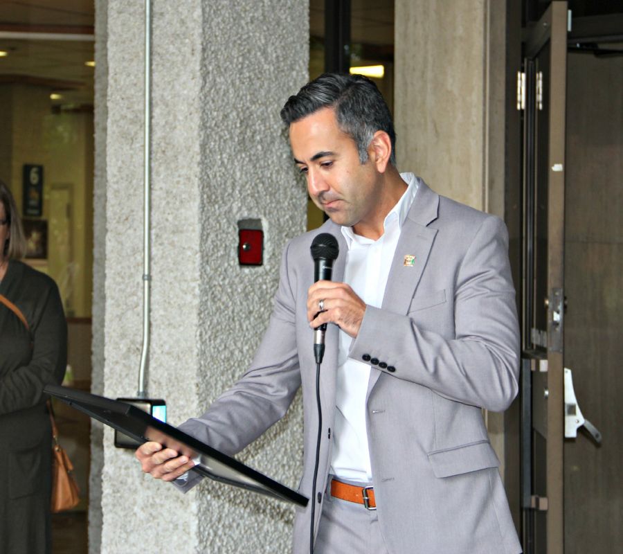 <who> Photo Credit: KelownaNow.com </who> Mayor Colin Basran reading the proclamation.