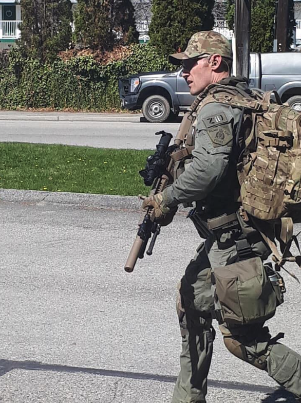 <who> Photo credit: Michael Miller </who> Police near the Empire Motel in Penticton