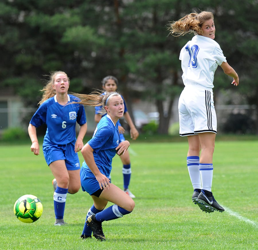 <who>Photo Credit: Lorne White/KelownaNow </who>Kelowna's Paige Cates heads the ball to a TOFC teammate in the first half on Sunday.