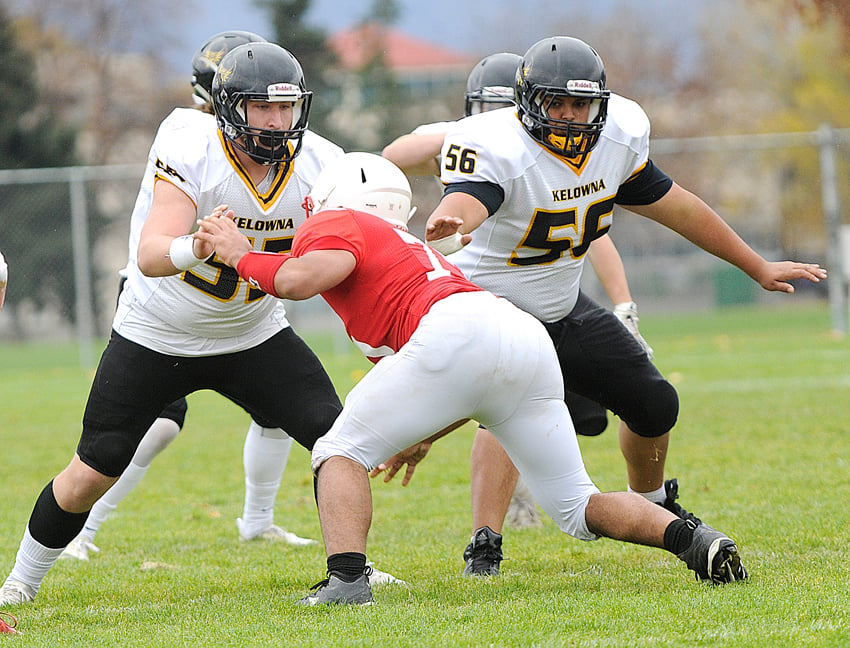 <who>Photo Credit: Lorne White/KelownaNow </who>Lucas Spencer, left, and Malik Prasad, right, led their team in trenches against Jamal Angell, centre, and the Mt. Boucherie Bears.