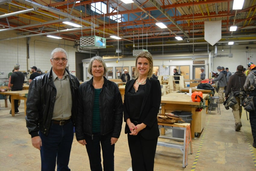 <who> Photo Credit: Okanagan College </who> Jim and Yvonne Lamb with Allison Ramchuk of the Okanagan College Foundation in the new carpentry shop at Okanagan College in Kelowna. 