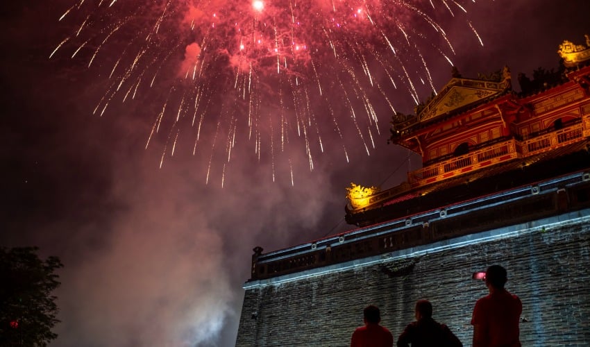 <who>Photo by Linh Pham/Getty Images</who>People watch the firework display in front of the Imperial City of Hue to mark the Lunar New Year or Tet celebrations on January 25, 2020 in Hue, Vietnam.