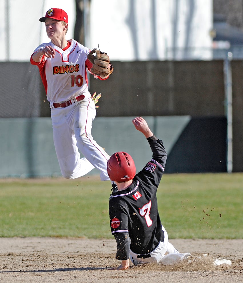 <who>Photo Credit: Lorne White/KelownaNow </who>Noah Nagle of the leaps over the Coyotes' Alex Russell at second base in an attempt at a double play.