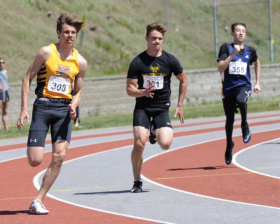 Caeleb Schlachter, left, of the KSS Owls ran to first in both the junior 100- and 200-metre dashes. Noah Gross, centre, finished second in both races. On the right is OKM's Nolan Humphries.