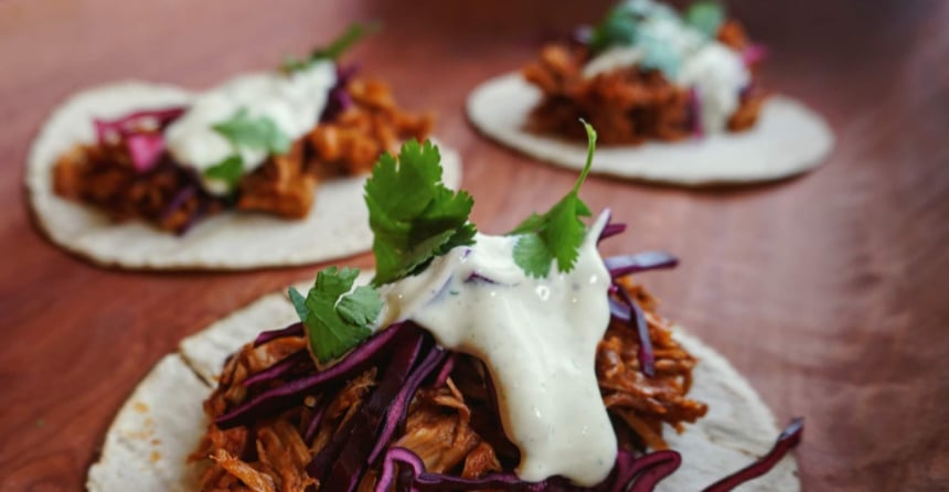 <who> Photo Credit: Veggie Bomb / Three atomic tacos made with bbq pulled jack fruit