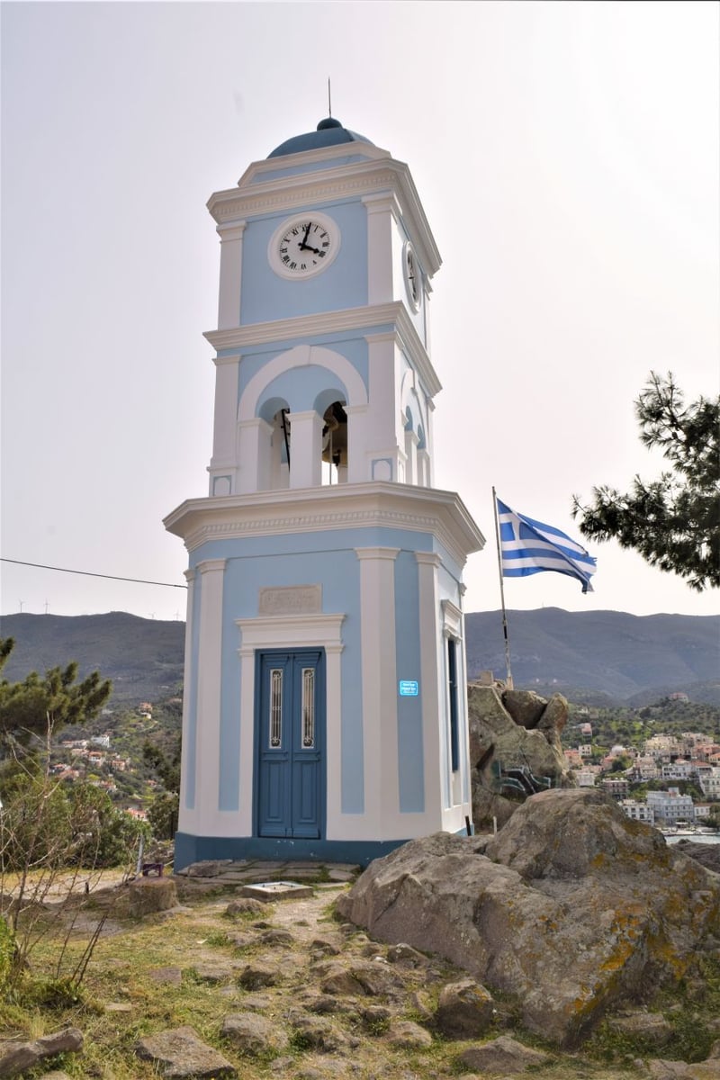 </who>The Clock Tower rises from the hilltop on the Greek island of Poros.