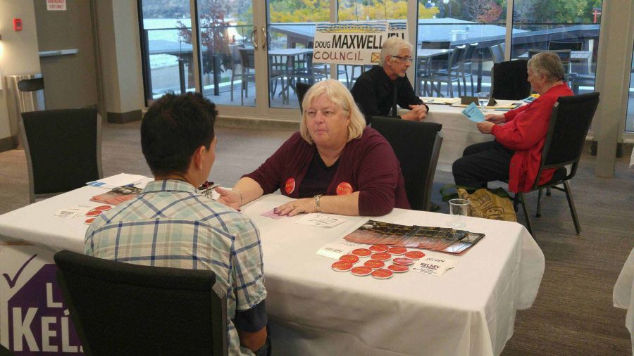 Penticton's Lynn Kelsey is one of 24 candidates vying for the six seats on Penticton Council in Saturday's general municipal election. She's seen talking to a local resident at a candidates trade show last week. Kelsey has only missed a handful of Penticton Council meetings over the past several years.