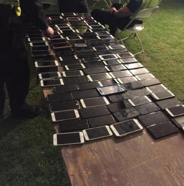 <who>Photo Credit: Indio Police Department</who>The phones laid out at the fesitval's security area.